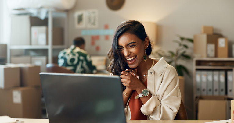 A happy women looking at her screen