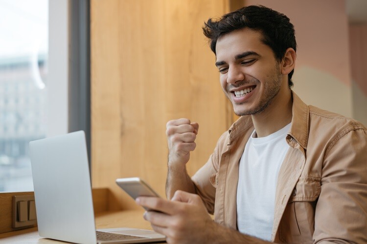 A person looking at phone joyfully