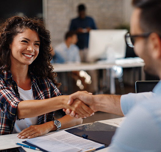 Two people shaking their hands.