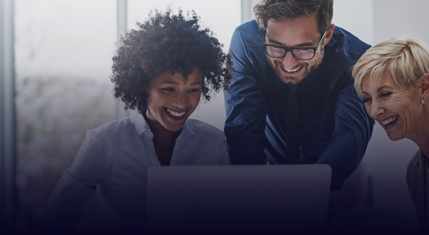 A team of 3 working on the laptop and smiling